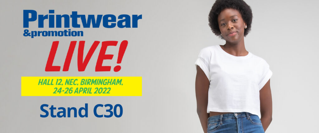 An image of woman wearing the M96 Crop Top in white, next to the text 'Printwear&Promorion Live! Hall 12, NEC, Birmingham, 24-26 April 2022. Stand C30'